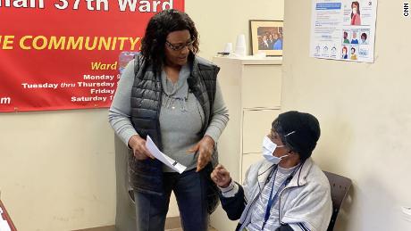 Alderman Emma Mitts, left, shares information about  her COVID vaccine experience. She also encourages her constituent, Bernice Hillman, 77, to get the vaccine. 