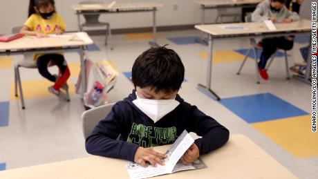 A first-grader works on an English exercise on the first day of class in Los Angeles on April 13, 2021. 