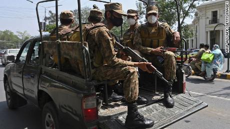 Army soldiers patrol on a street to implement new restrictions against Covid-19 in Lahore, Pakistan, on April 26.