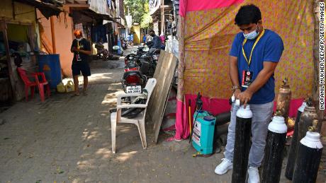 Shahnawaz Shaikh checks the pressure of an oxygen cylinder at a distribution center in  Mumbai on April 28, 2021.