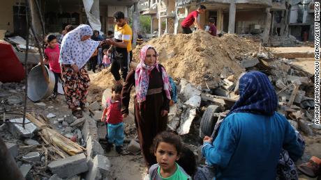 Palestinians return Friday to homes that were destroyed by Israeli airstrikes in Beit Hanoun, Gaza.