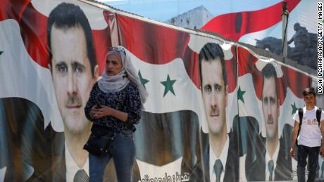 Syrians vote in 'non-event' presidential election set to be won by Assad