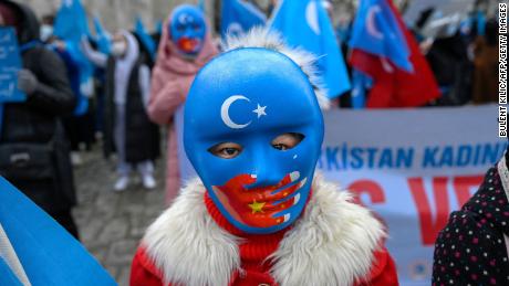 A child from the Uyghur community living in Turkey wears a mask during a protest against the visit of China's Foreign Minister to Turkey, in Istanbul on March 25, 2021.