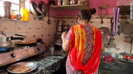 Devika's sister prepares food in the kitchen of their New Delhi home on June 2, 2021.