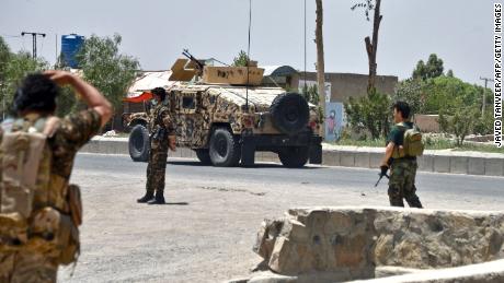 Afghan security personnel stand guard during fighting between Afghan security forces and Taliban fighters in Kandahar on July 9.