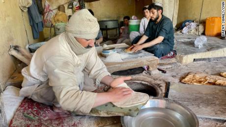 At night a curfew takes hold in Kandahar and cellular communications are cut; during the day markets open to fewer shoppers buying essential items. 