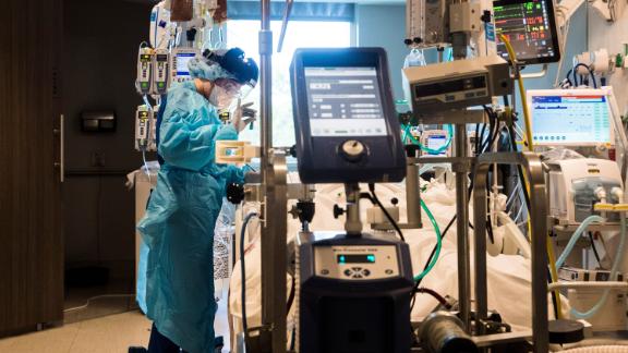Nichole Arevalo, an R.N. at the downtown campus of NCH in Naples, Florida, treats a Covid-19 patient in the Intensive Care Unit on August 9, 2021.